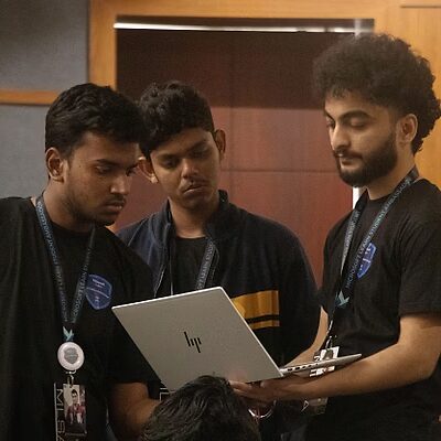 Arpit teaching students with a laptop